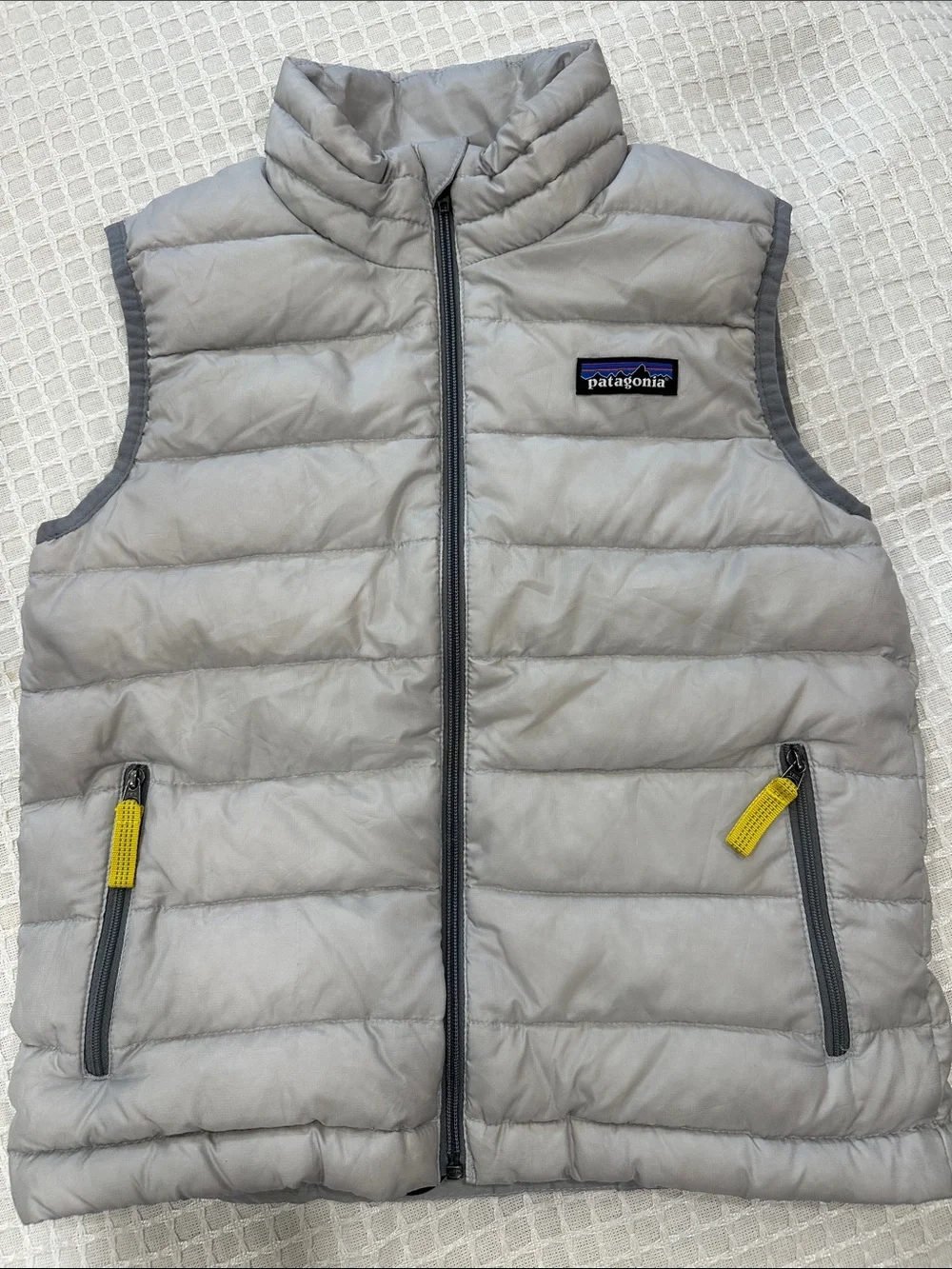 Patagonia Kids Light Gray Puffer Vest with Yellow Pull Tabs